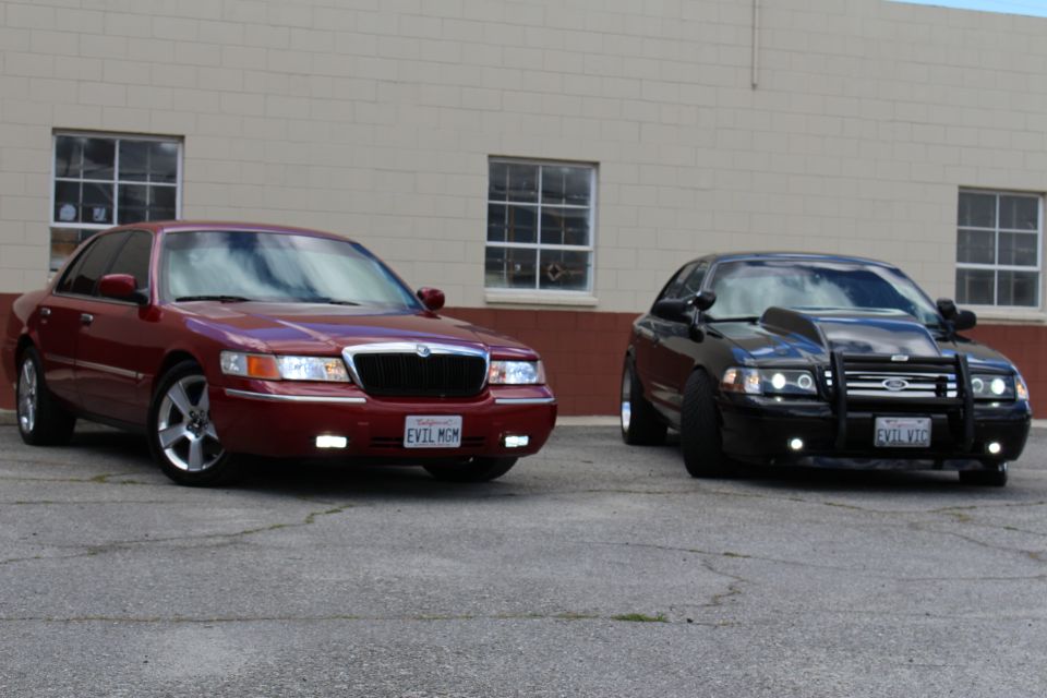 Maroon Mercury Grand Marquis and black Crown Victoria with bull bar, EVIL plates