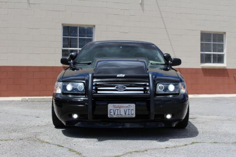 2003 Ford Crown Victoria - black Ford Crown Victoria sits low with a brush guard, halo headlights and a California 'EVIL VIC' license plate.