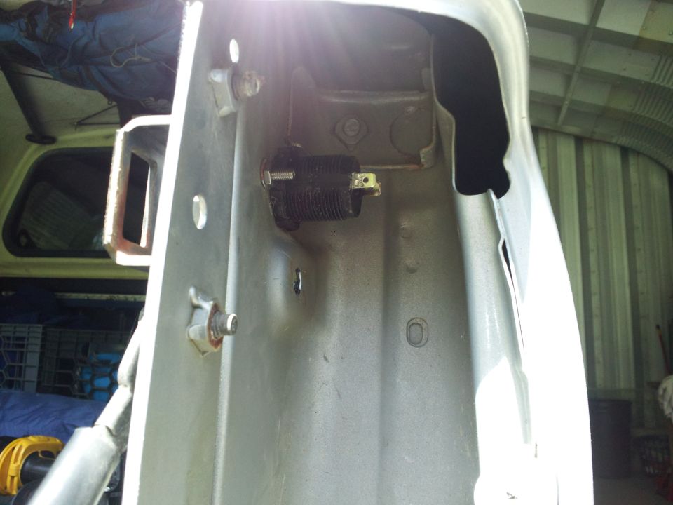 Close-up of vehicle frame with black electrical component