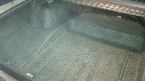 1963 Chevrolet Nova - The trunk interior of a 1963 Chevrolet Nova features a textured lining and a spare tire well, indicative of its model year.