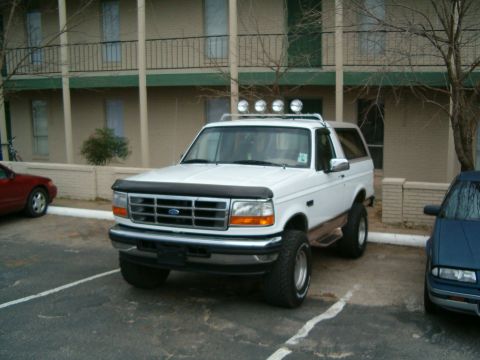 1996 Ford Bronco - White 1996 Ford Bronco with a light bar parked in a lot.