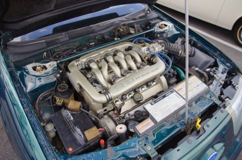1995 Ford Taurus - Engine bay of a 1995 Ford Taurus SHO, highlighting the V6 DOHC engine and surrounding components.