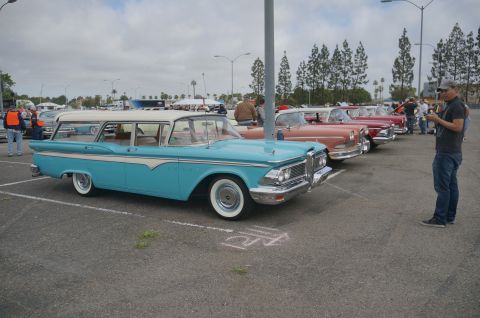 1995 Ford Taurus - A turquoise and white station wagon is parked in a line of classic cars at an outdoor event.