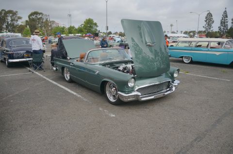 1995 Ford Taurus - 1957 Ford Thunderbird convertible on display with its hood open, showing the engine.