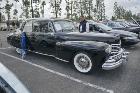 1995 Ford Taurus - A classic black Lincoln Continental is displayed at an outdoor car event with other vehicles present.