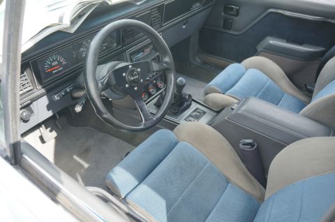 1995 Ford Taurus - Interior view of a car with aftermarket steering wheel and gauges.