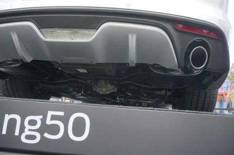 1995 Ford Taurus - The rear of a car is shown, with a focus on the bumper and exhaust system, and the text 'ng50' visible on a platform.