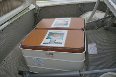1995 Ford Taurus - The trunk of a car contains two brown suitcases and several caution labels, including one that reads 'LOOK! DO NOT STICK ANYTHING IN HERE!'