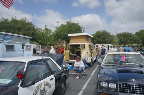 1995 Ford Taurus - A black and white Ford Mustang SSP police car is parked at an outdoor car show.