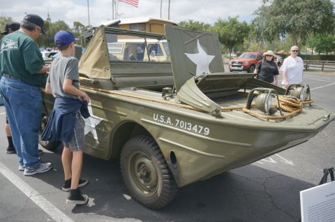 1995 Ford Taurus - Olive drab military amphibious vehicle with white star and U.S.A. 7013479 markings on display.