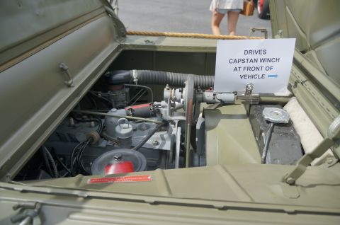 1995 Ford Taurus - The engine compartment of a military vehicle is open, showing the engine and a sign about its winch.