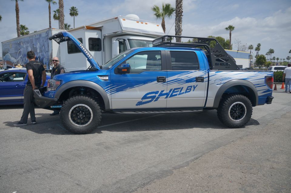 Blue and silver Ford F-150 SVT Raptor with Shelby graphics, hood open