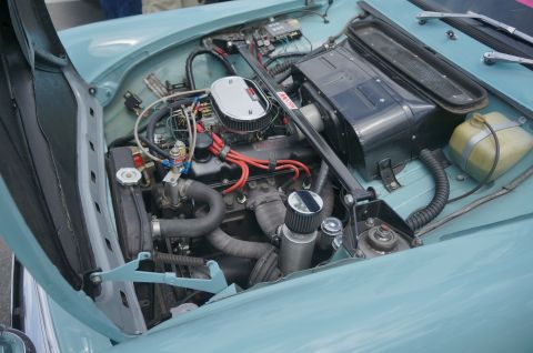 1995 Ford Taurus - Close-up of a car's engine bay, showing the V6 engine and various components.