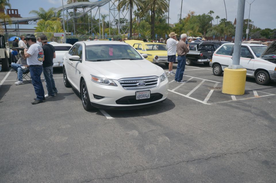 White Ford sedan parked in a lot, front view. License plate reads 6R0A846