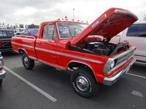 1994 Ford Bronco - This red Ford pickup truck, likely from the early 1970s, is shown with its hood open, revealing the engine compartment.