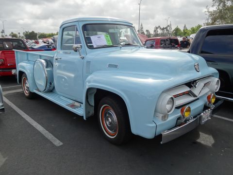 1994 Ford Bronco - This classic 1956 Ford F-100 pickup truck is parked at an outdoor event.