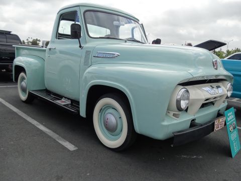 1994 Ford Bronco - This vintage Ford F-100 pickup truck features a two-tone grille and whitewall tires.
