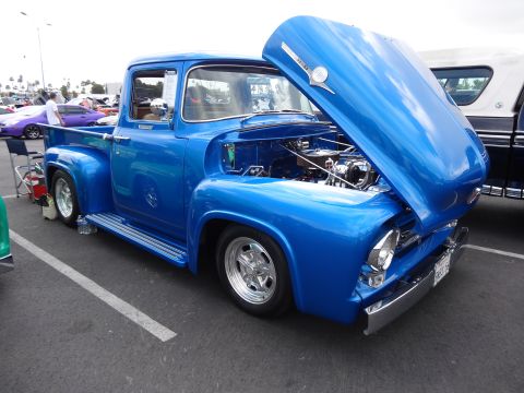 1994 Ford Bronco - This bright blue 1956 Ford F-series truck is displayed with its hood open, revealing the engine bay.