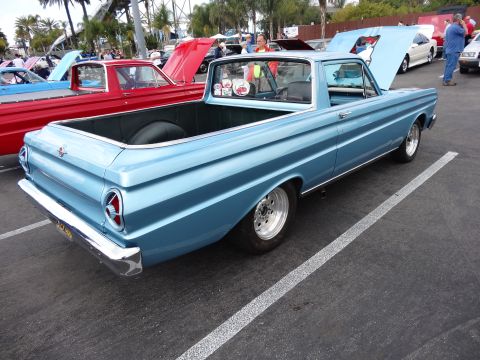 1994 Ford Bronco - A light blue 1964 Ford Falcon Ranchero is parked next to a red pickup truck.