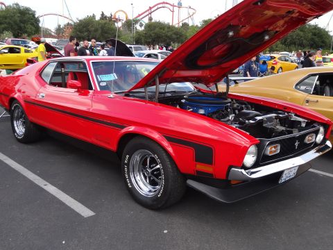 1994 Ford Bronco - Red 1971 Ford Mustang coupe with engine exposed at a car show.