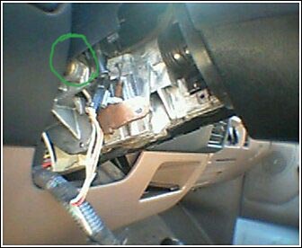 1992 Ford Bronco - Exposed wiring and components are visible beneath the dashboard of a vehicle, with a green circle marking a particular spot.