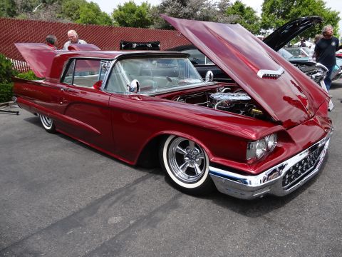 1994 Ford Bronco - Custom 1958 Ford Thunderbird with its hood open, displaying the engine and chrome wheels.