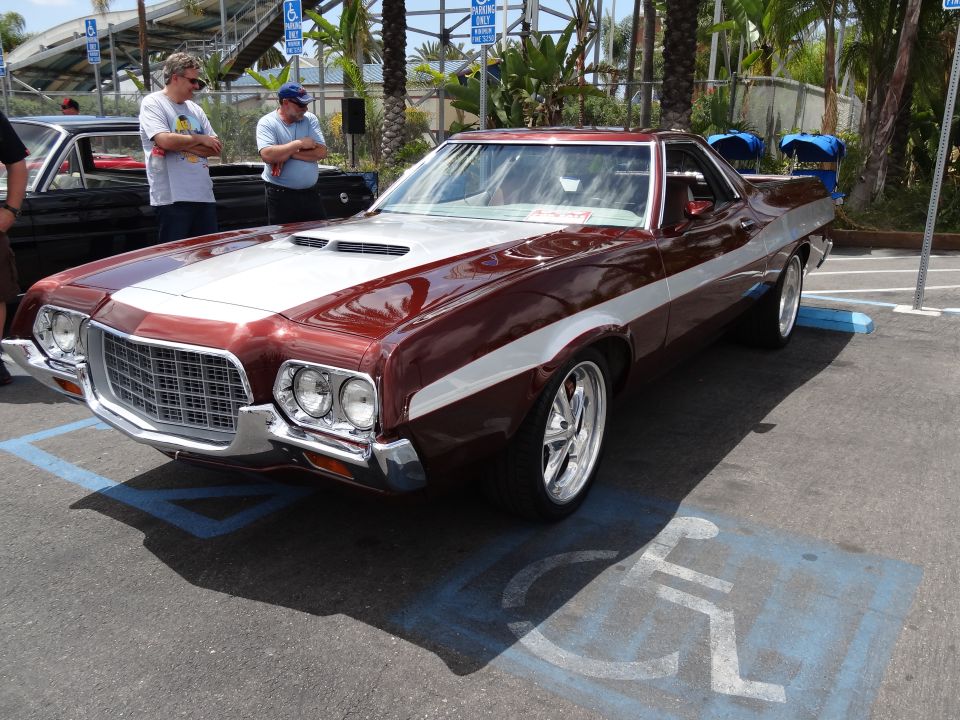 Maroon and silver Ford Ranchero parked in a handicapped spot