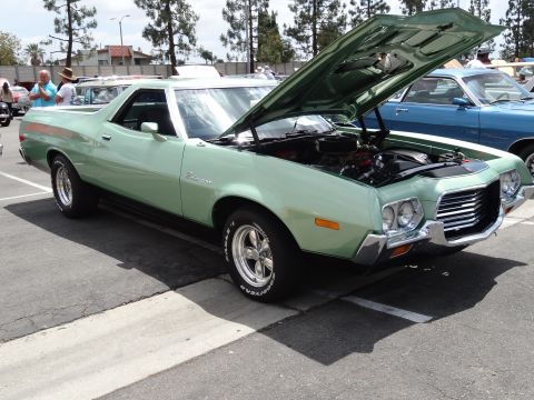 1994 Ford Bronco - A light green 1972 Ford Ranchero pickup truck is parked with its hood open, revealing the engine bay.