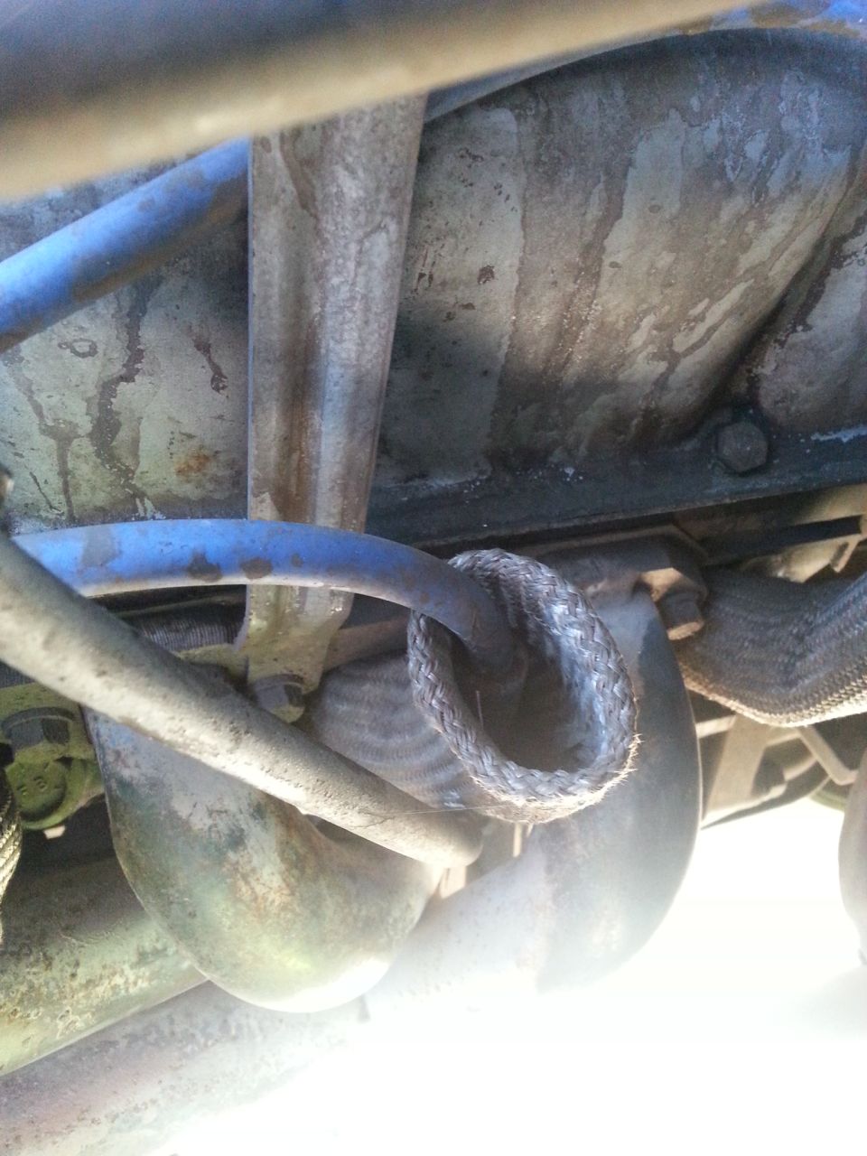 Close-up of braided hose and metal pipes in an engine bay