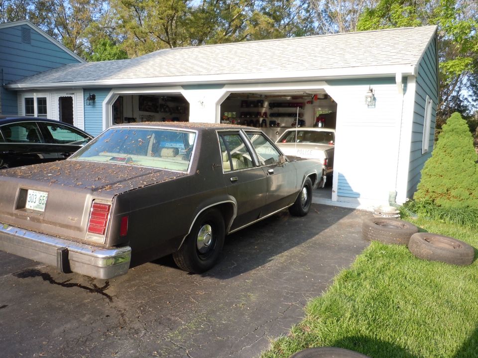 Brown 1980 Ford LTD Crown Victoria sedan, rear view, parked in driveway