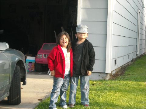 1988 Ford Bronco - A pink toy SUV is parked in a garage behind two children.