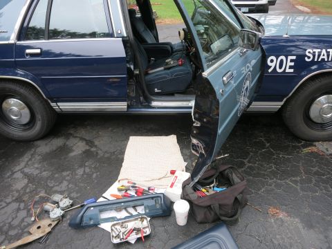 1991 Ford LTD Crown Victoria - Interior view of a 1991 Ford Crown Victoria LTD with the driver's door open and parts removed for repair.
