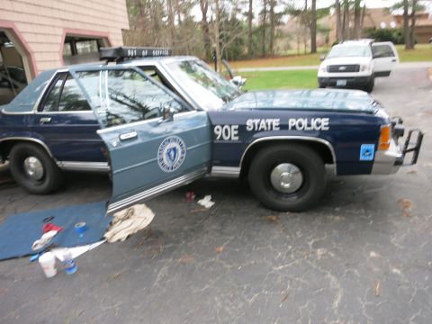 1991 Ford LTD Crown Victoria - Police Crown Victoria with doors open, showing 'STATE POLICE' text and Massachusetts seal.