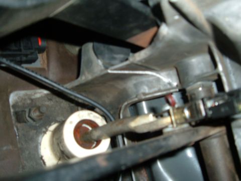 1988 Ford Bronco - Detail shot of a vehicle's transmission linkage mechanism, showing various mechanical parts.