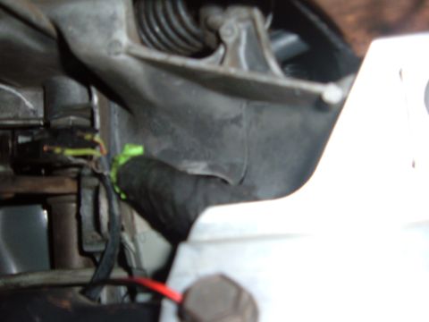 1988 Ford Bronco - A close-up view of a vehicle's wiring harness, showing electrical connections and protective wrapping.