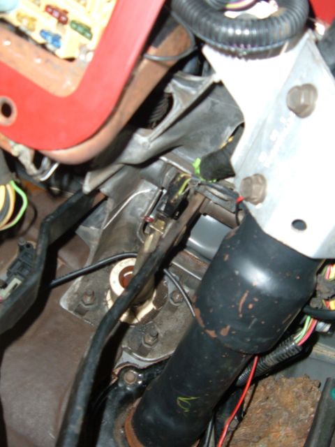 1988 Ford Bronco - Interior view of a vehicle's steering column and associated wiring, with a visible fuse box.
