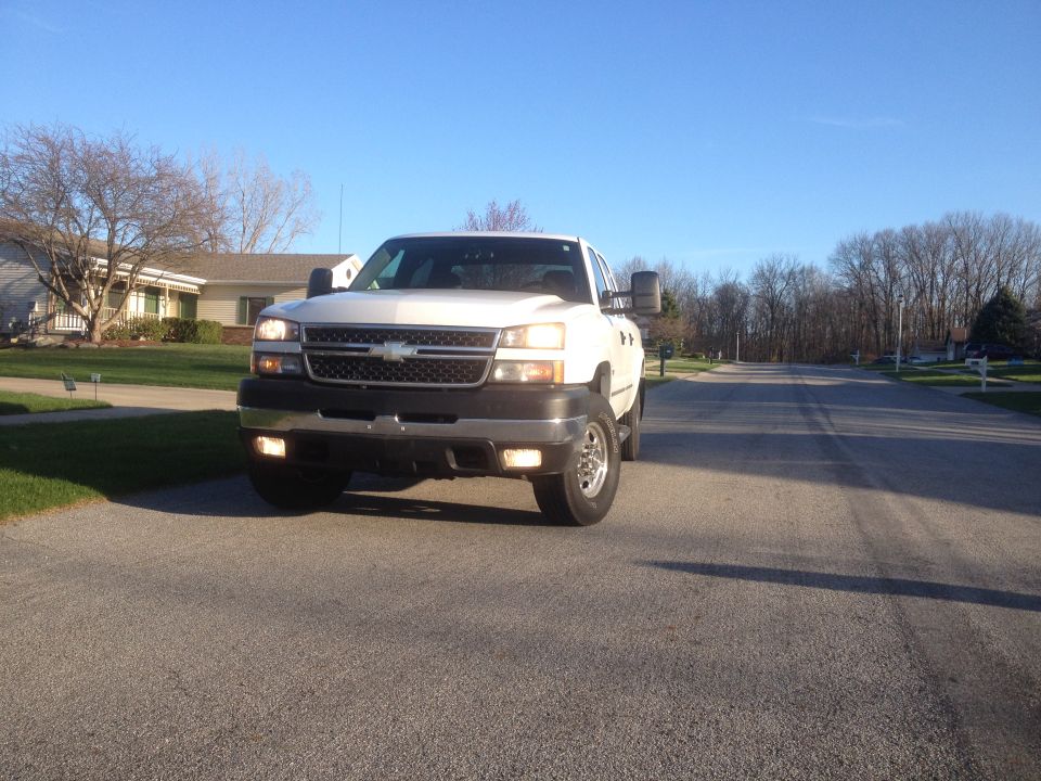 White 2006 Chevrolet Silverado 2500 parked on a residential street