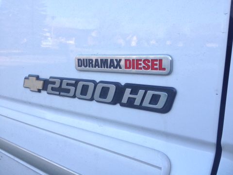 2006 Chevrolet Silverado 2500 - Close-up of Duramax Diesel and 2500 HD badges on a white vehicle.