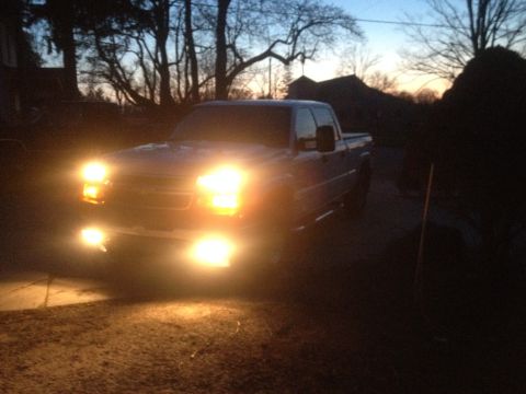 2006 Chevrolet Silverado 2500 - A 2006 Chevrolet Silverado 2500 pickup truck is seen at dusk with its lights on.