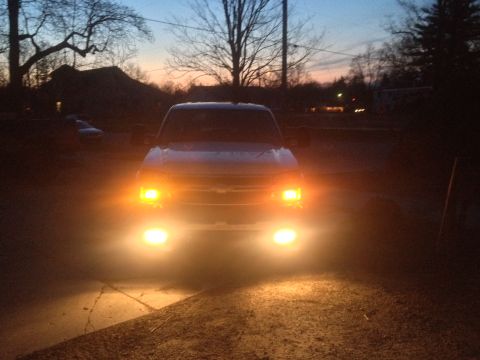 2006 Chevrolet Silverado 2500 - Truck's headlights and fog lights are on during twilight. The grille suggests a 2003 model.