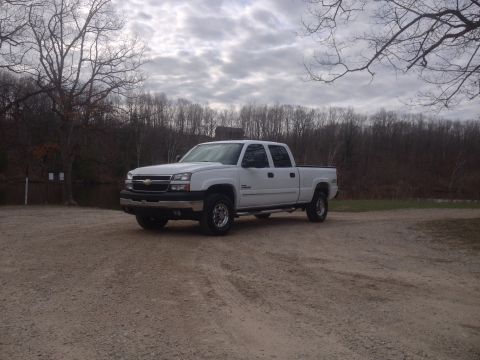 2006 Chevrolet Silverado 2500 - White 2006 Chevrolet Silverado 2500 pickup truck parked outdoors under a cloudy sky.