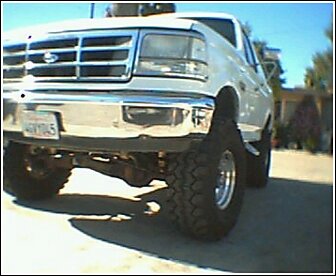 1992 Ford Bronco - Front view of a white 1992 Ford Bronco, modified with a lift kit and oversized tires.