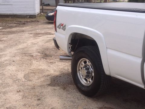 2006 Chevrolet Silverado 2500 - Rear view of a white pickup truck, showing the 4x4 badging on the quarter panel.