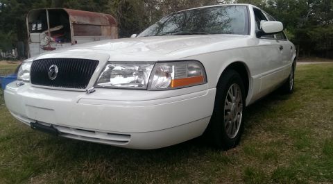2000 Mercury Grand Marquis - This white 2000 Mercury Grand Marquis is shown from a 3q-front angle, parked outdoors.