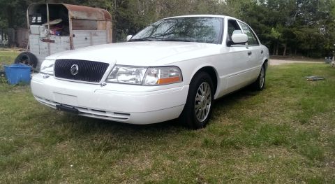 2000 Mercury Grand Marquis - White 2000 Mercury Grand Marquis LSE sedan parked outdoors in a grassy area.