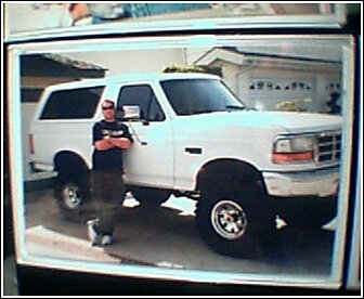 1992 Ford Bronco - A man poses with his white Ford Bronco in front of a house.