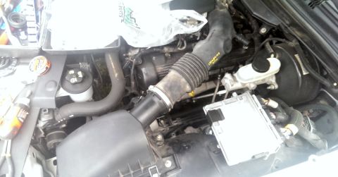 2000 Mercury Grand Marquis - The engine bay of a vehicle is shown with various components and hoses.