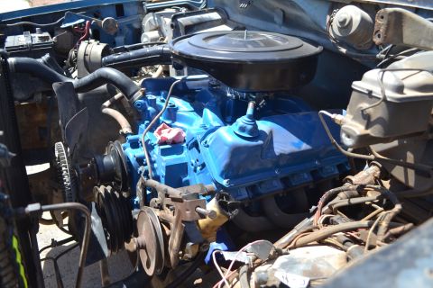 1981 Ford F-250 - Close-up of a blue engine in an engine bay, showing various components and wiring.