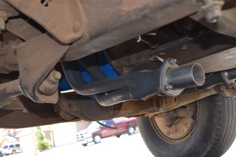 1981 Ford F-250 - Underside view of exhaust system components, with another vehicle visible in the background.