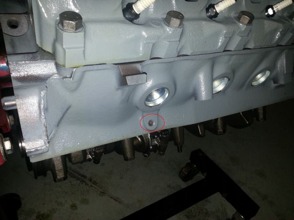 Close-up of a gray engine block with spark plugs visible